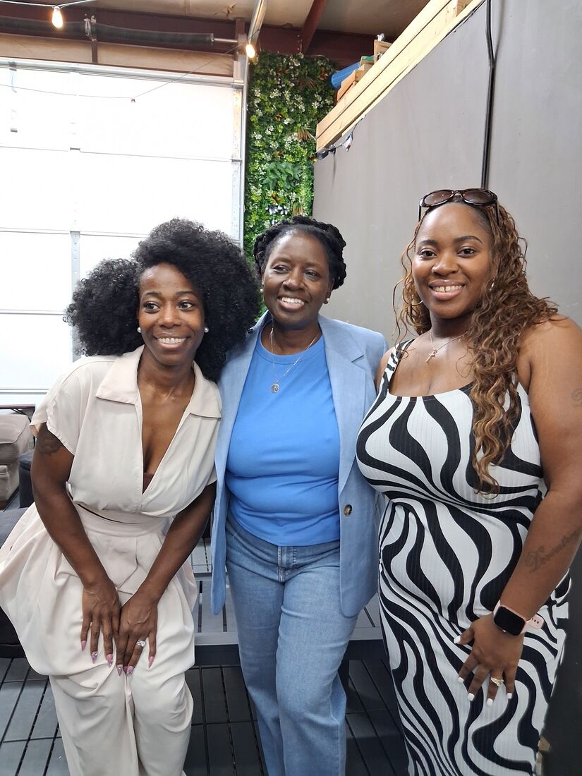 Wander Franklin with her daughters, smiling together at an event