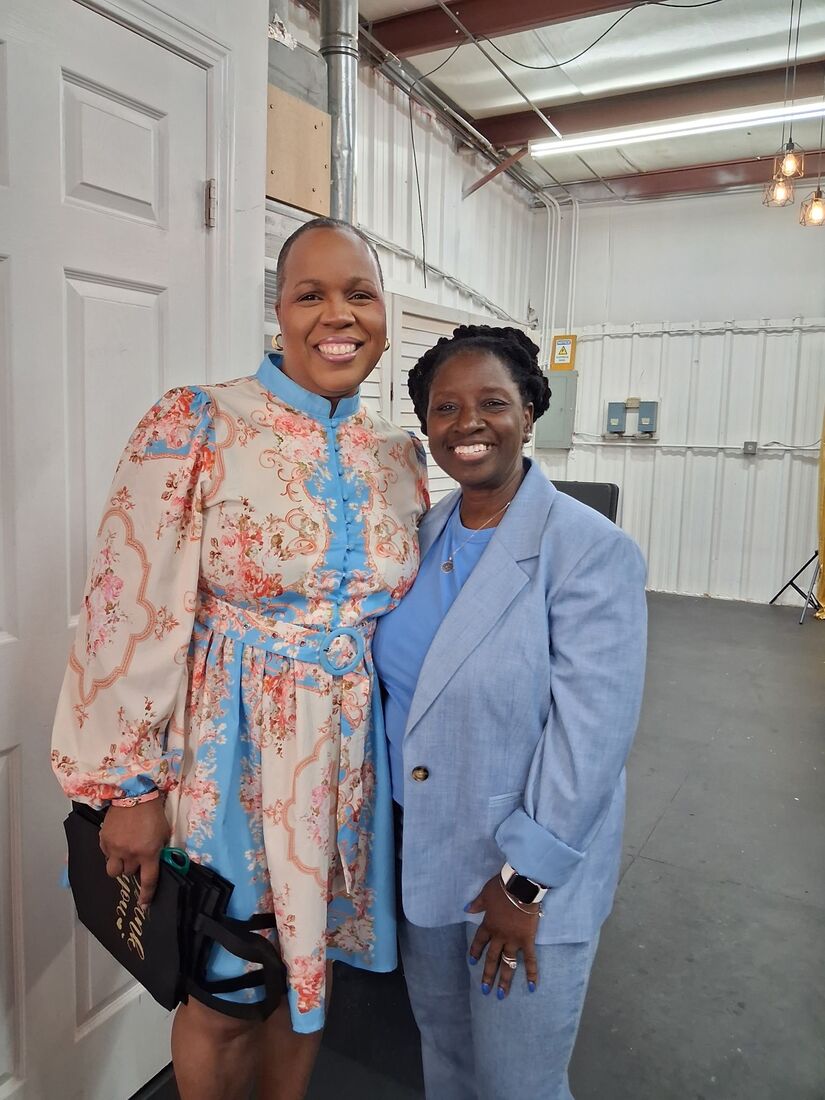 Wander Franklin with a partner in a floral dress at an event